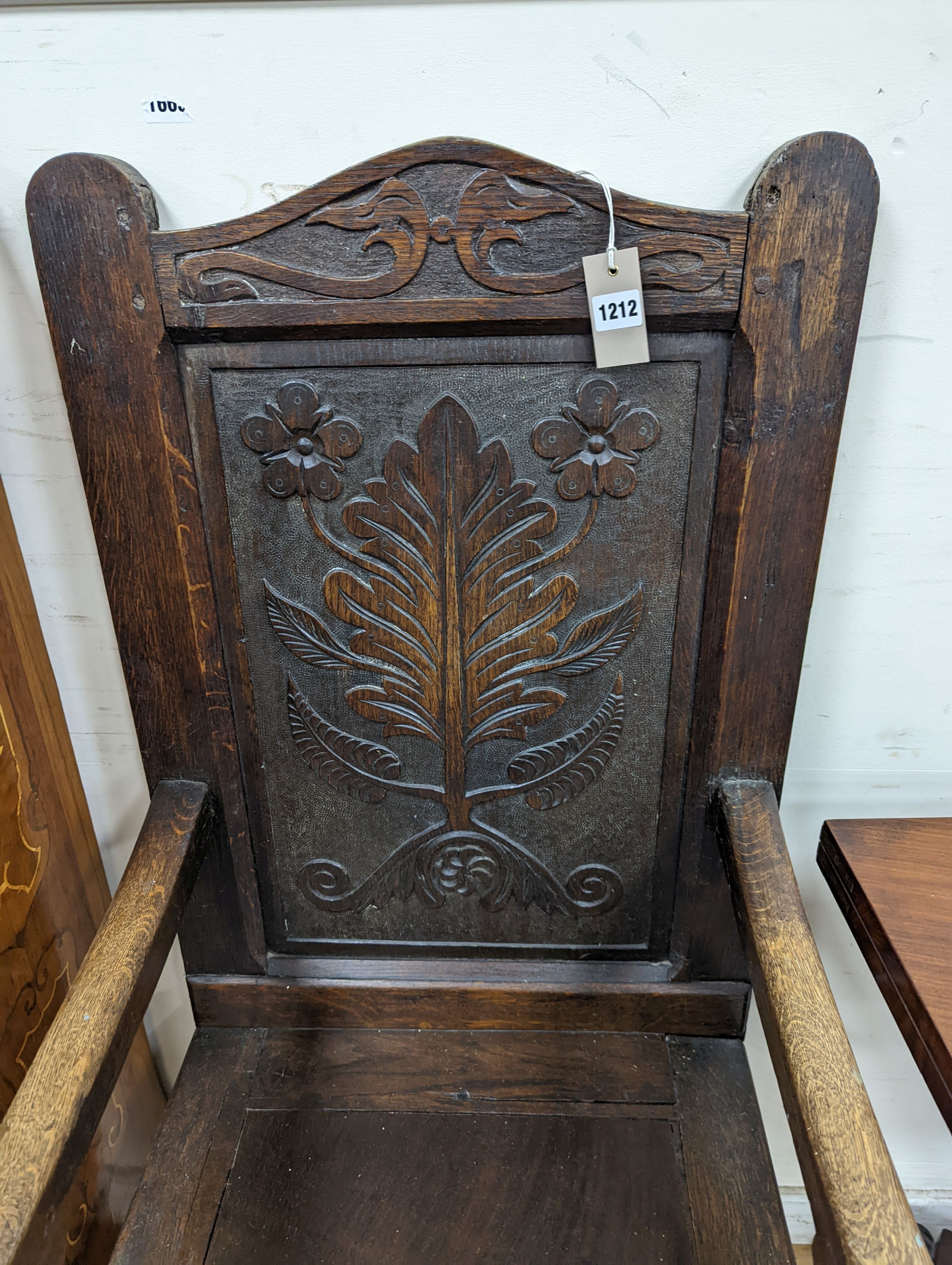 A 17th century style oak wainscot chair, width 54cm, height 122cm